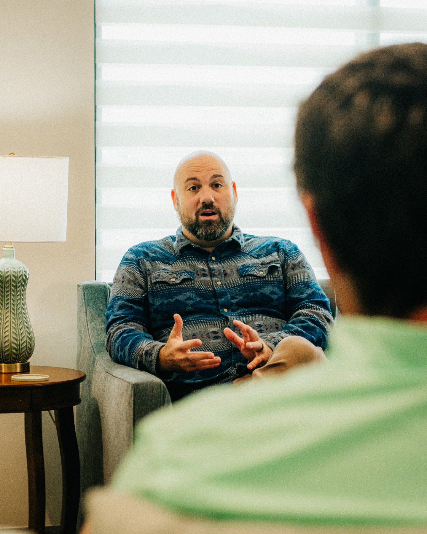 A provider talking with a client in his counseling room
